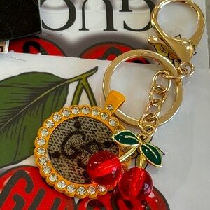 Gold and Red Cherry Keychain with extra detail to a yellow crystal and leather